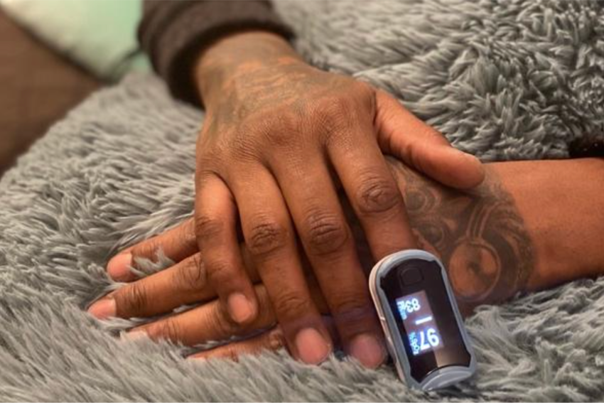 person wearing pulse oximeter